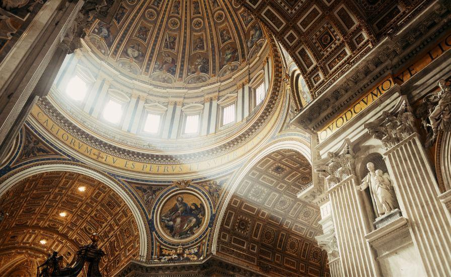 Inside St. Peter's Basilica, a majestic cathedral with a grand dome, showcasing historical treasures.