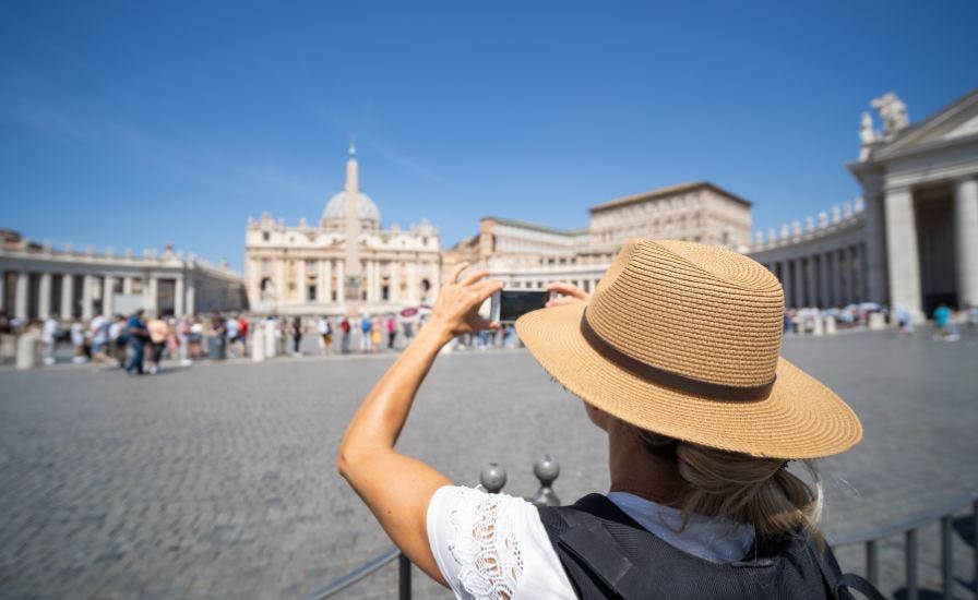 A-woman-in-a-hat-capturing-the-Vatican-in-her-photograph.-Tips-for-Visitors-St.-Peters-Basilica